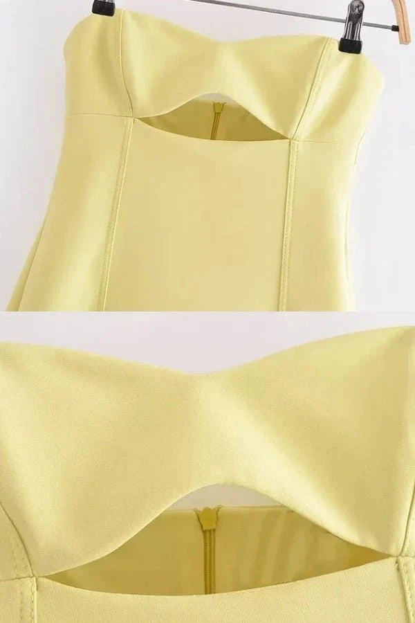 Model wearing the Kouvr Fashion yellow strapless cutout mini dress from the front