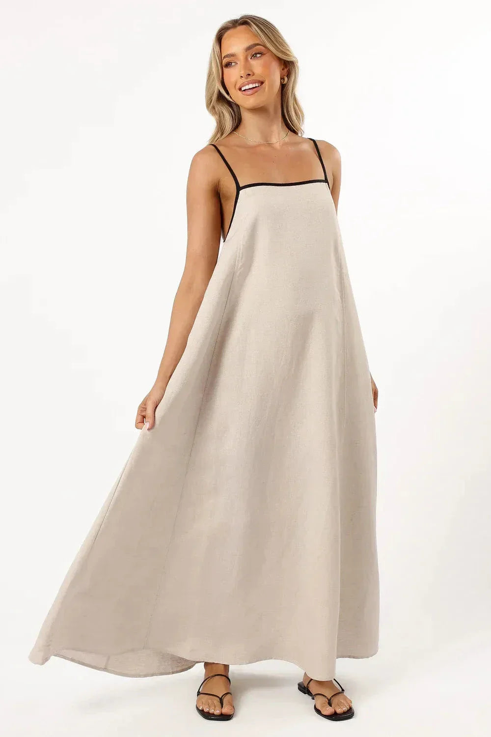 Model wearing Kouvr Akisha natural linen maxi dress with open back tie