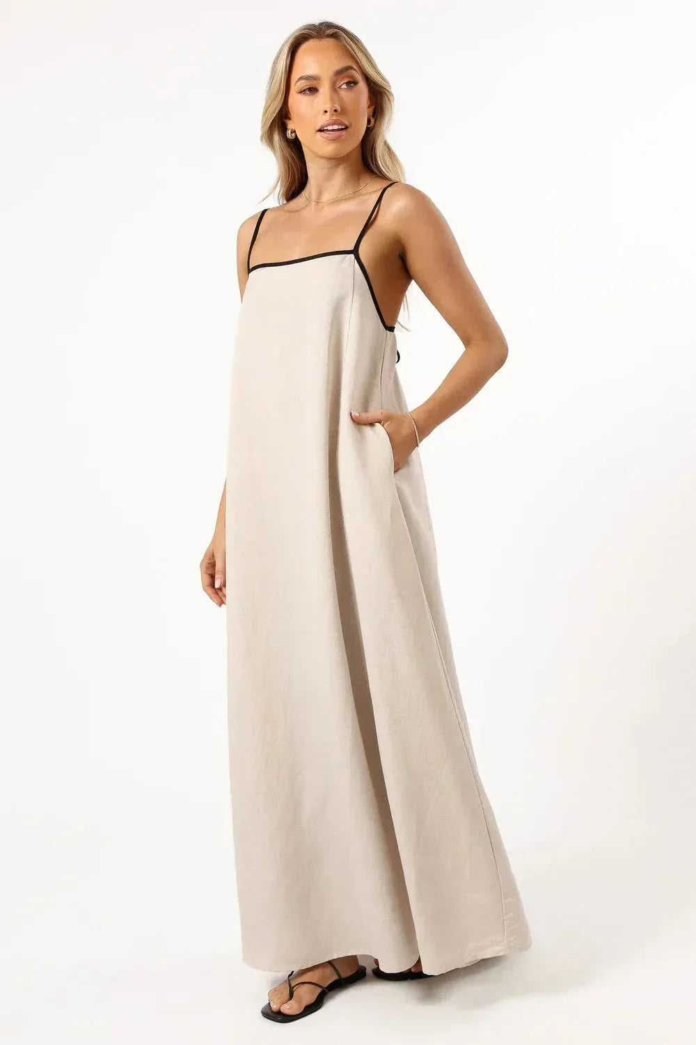 Model wearing Kouvr Akisha natural linen maxi dress with open back tie