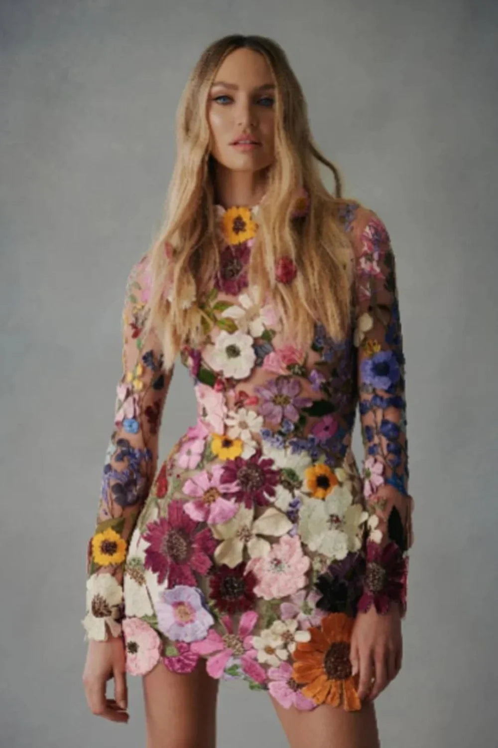 Model wearing Kouvr floral embroidered mini dress at a luxury event
