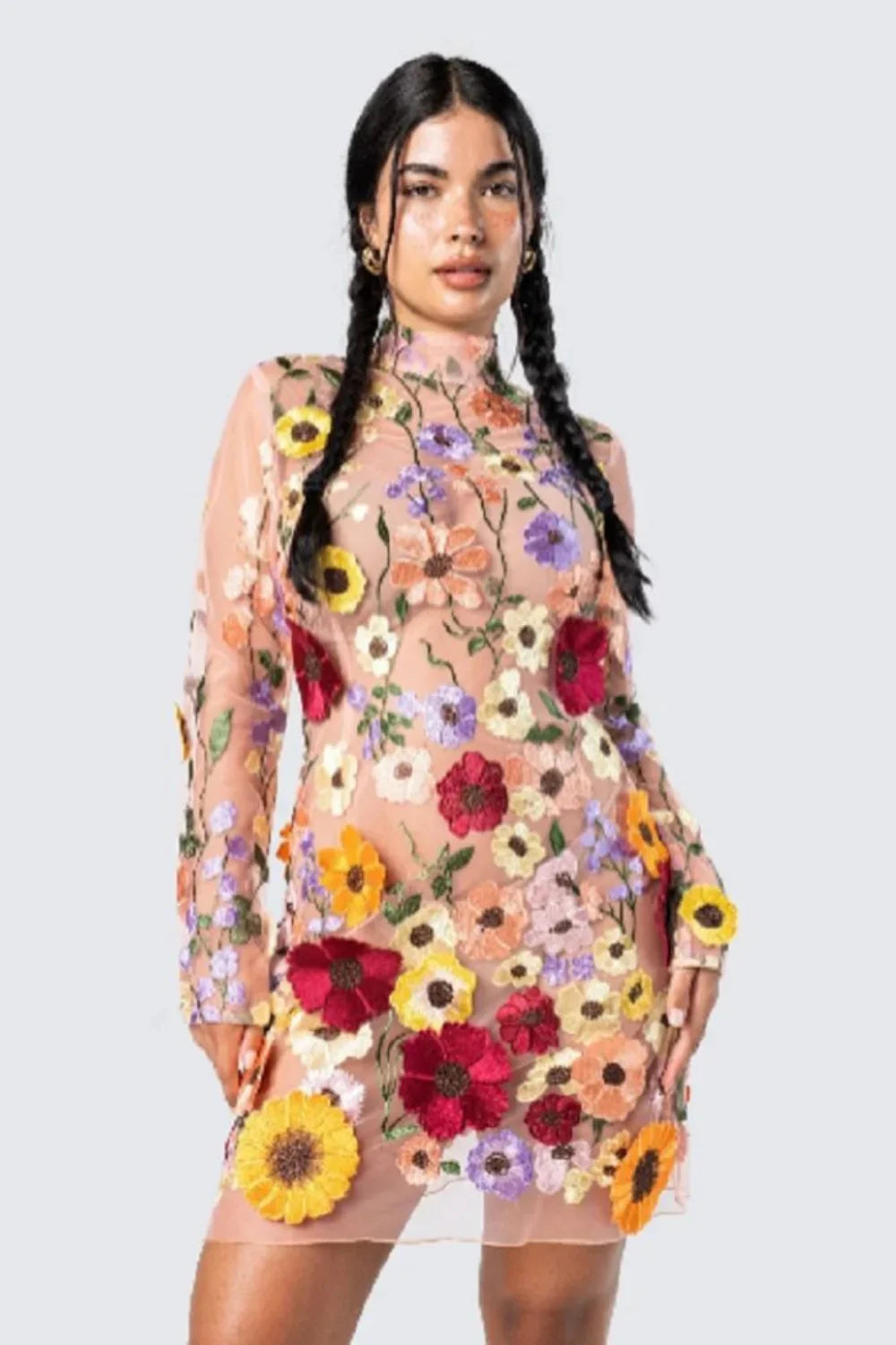 Model wearing Kouvr floral embroidered mini dress at a luxury event