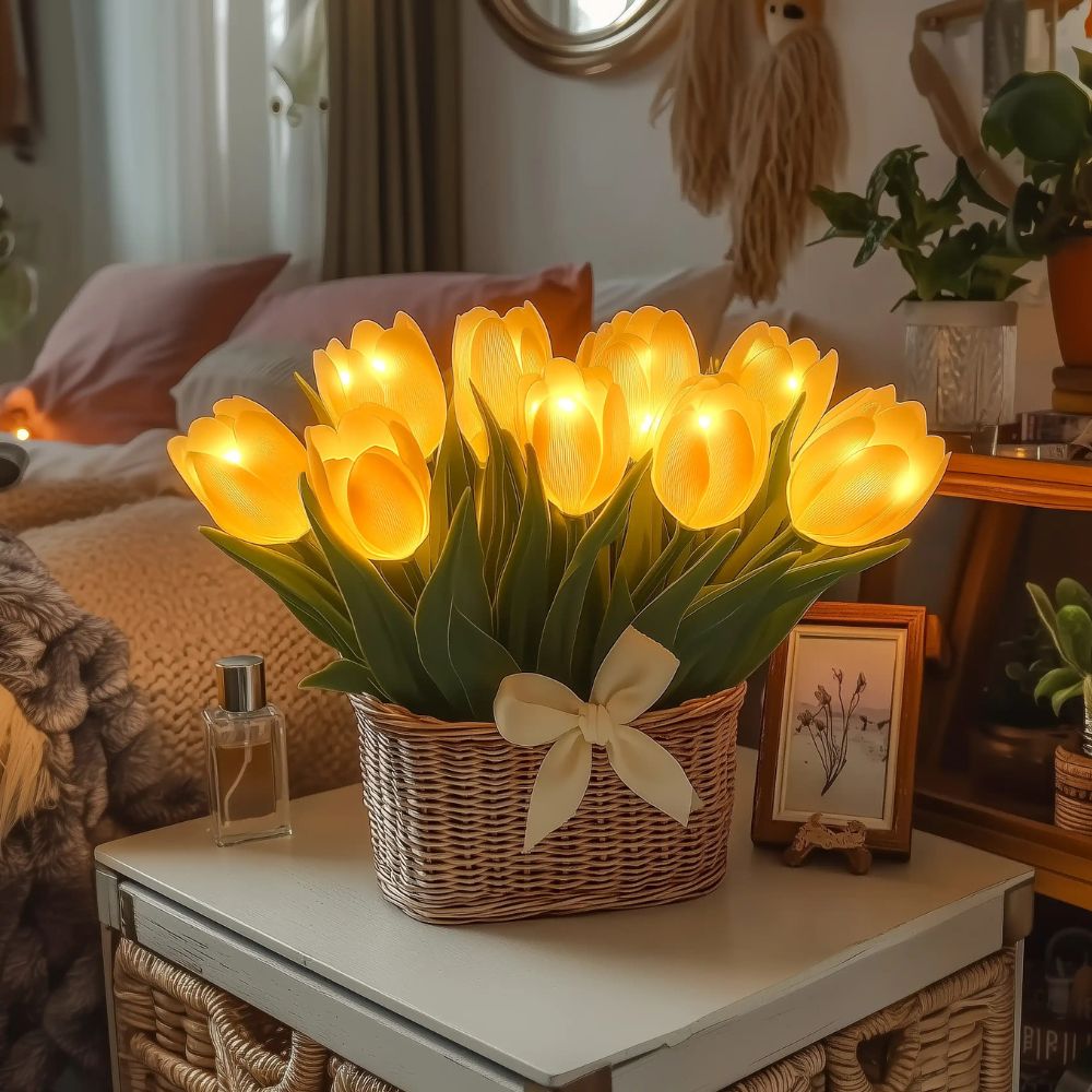 Kouvr Petal Dreams Basket with 12 glowing yellow tulips in a wicker basket on a wooden console table
