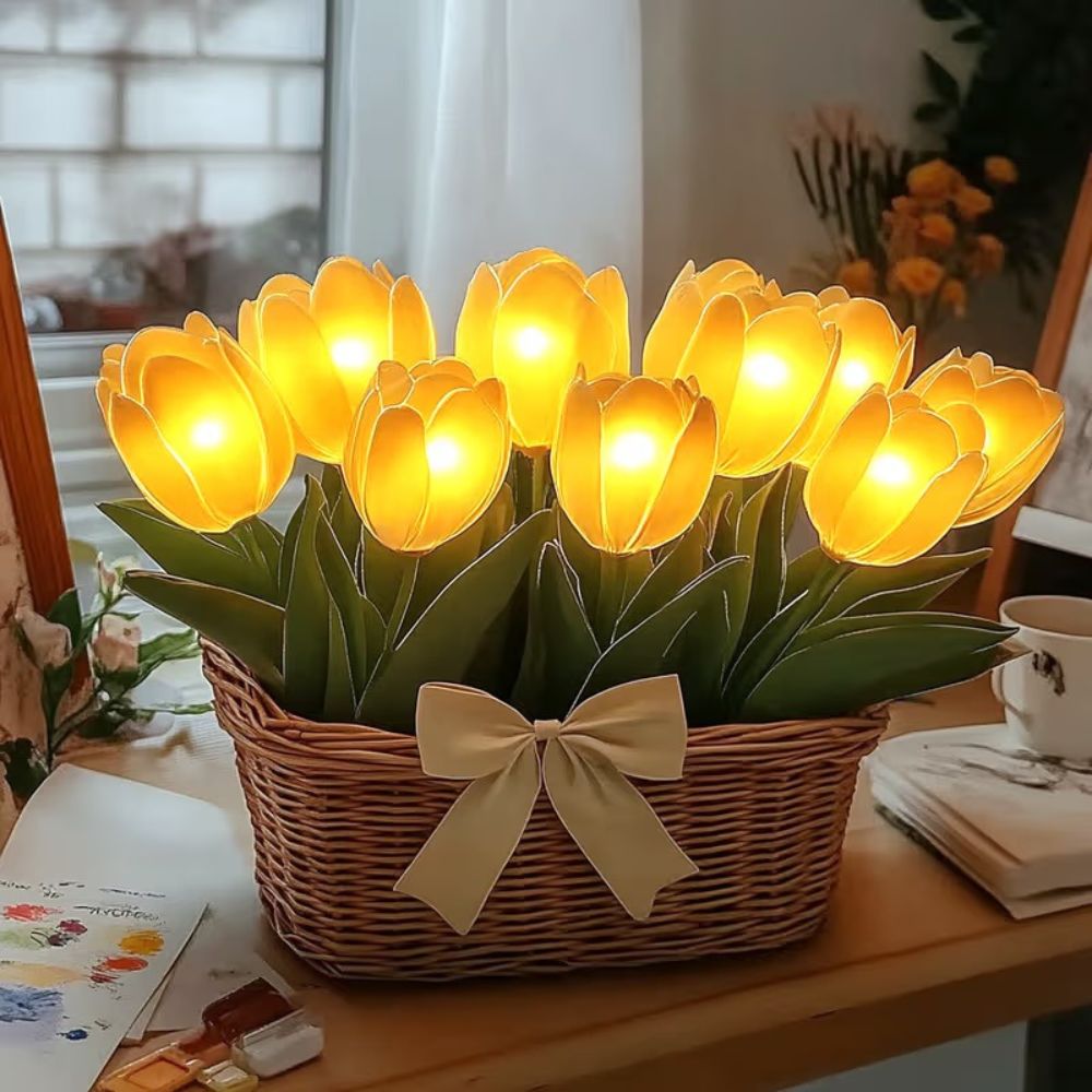 Kouvr Petal Dreams Basket with 12 glowing yellow tulips in a wicker basket on a wooden console table