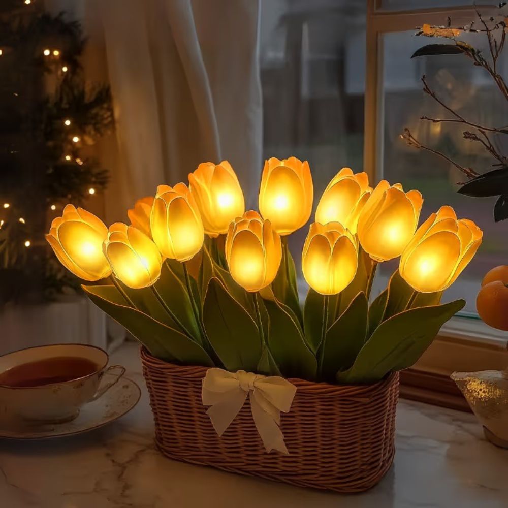 Kouvr Petal Dreams Basket with 12 glowing yellow tulips in a wicker basket on a wooden console table