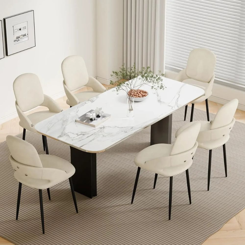 Dining room with a marble table and white chairs in a modern interior setting.