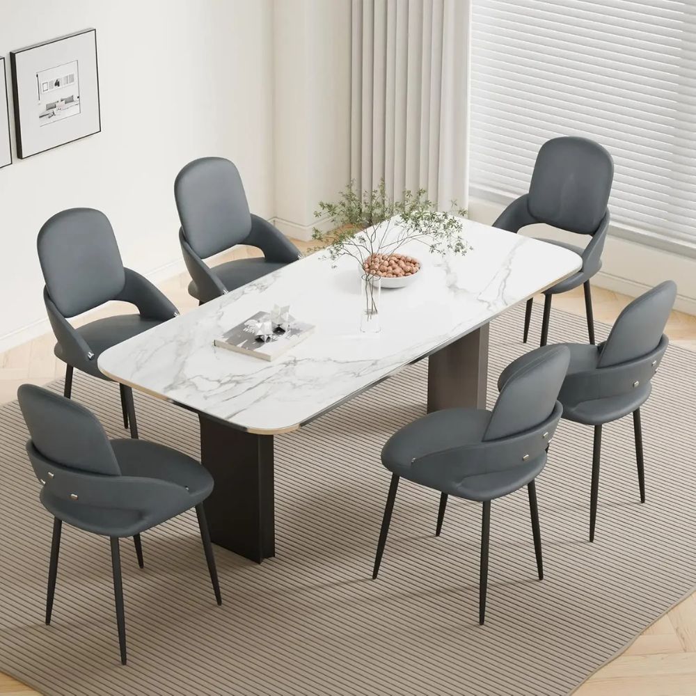 Dining table set with marble surface and six dark gray kouvr chairs in a modern room.