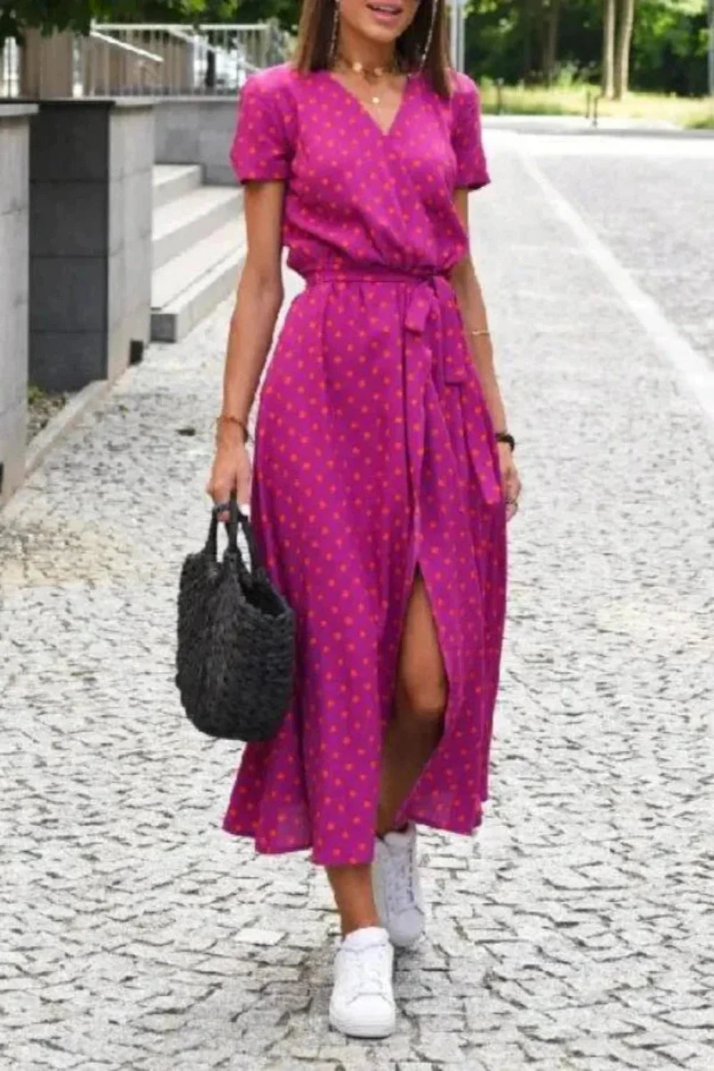 Full-length street style view of the Aleia magenta polka dot dress.
