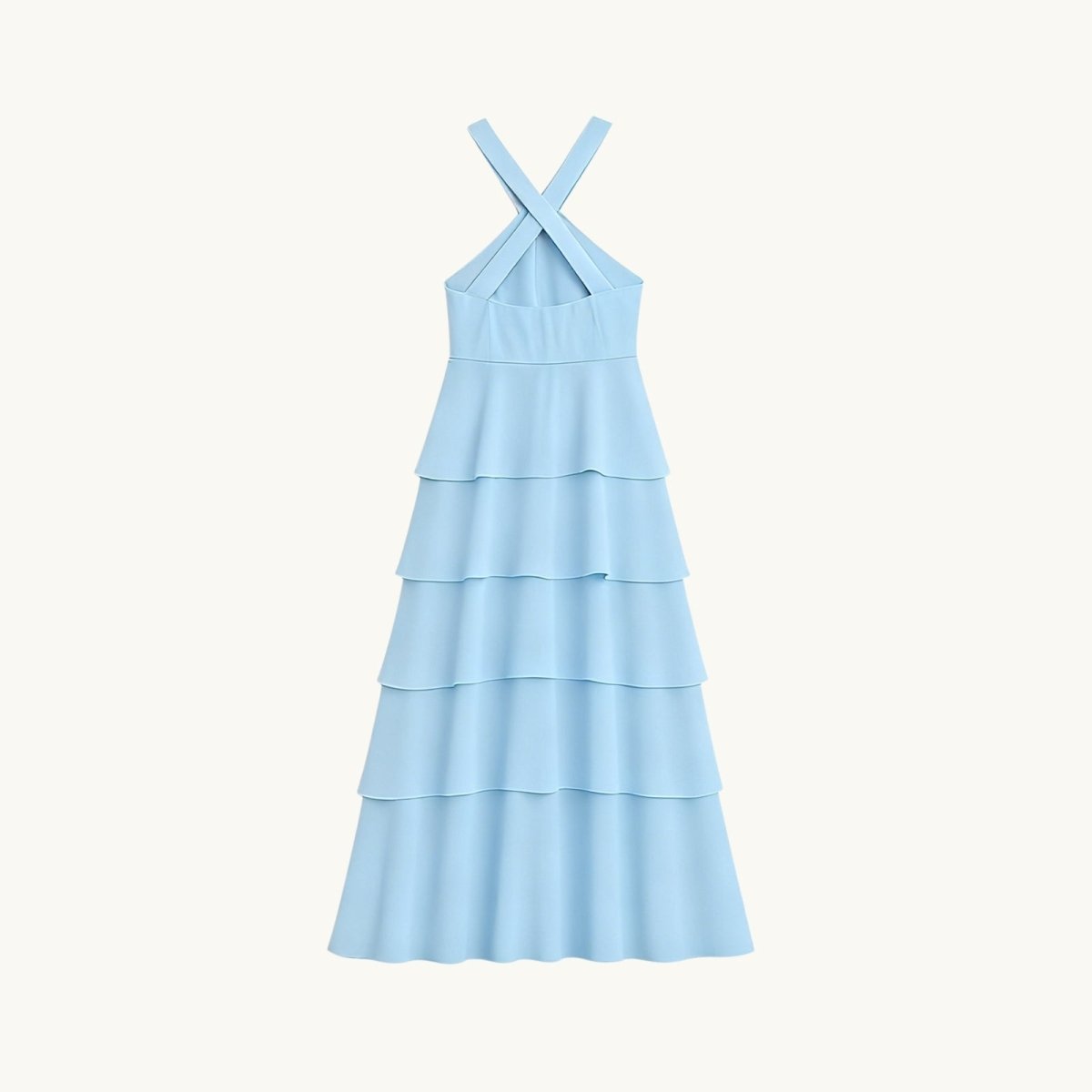 Light blue Kouvr tiered dress with criss-cross straps on a white background