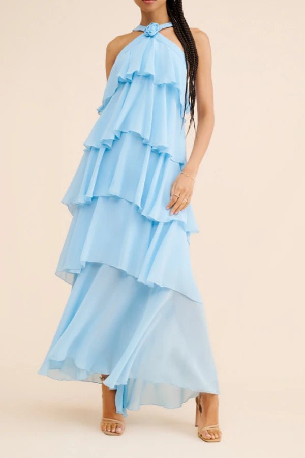 Light blue ruffled Kouvr dress worn by a model on a beige background