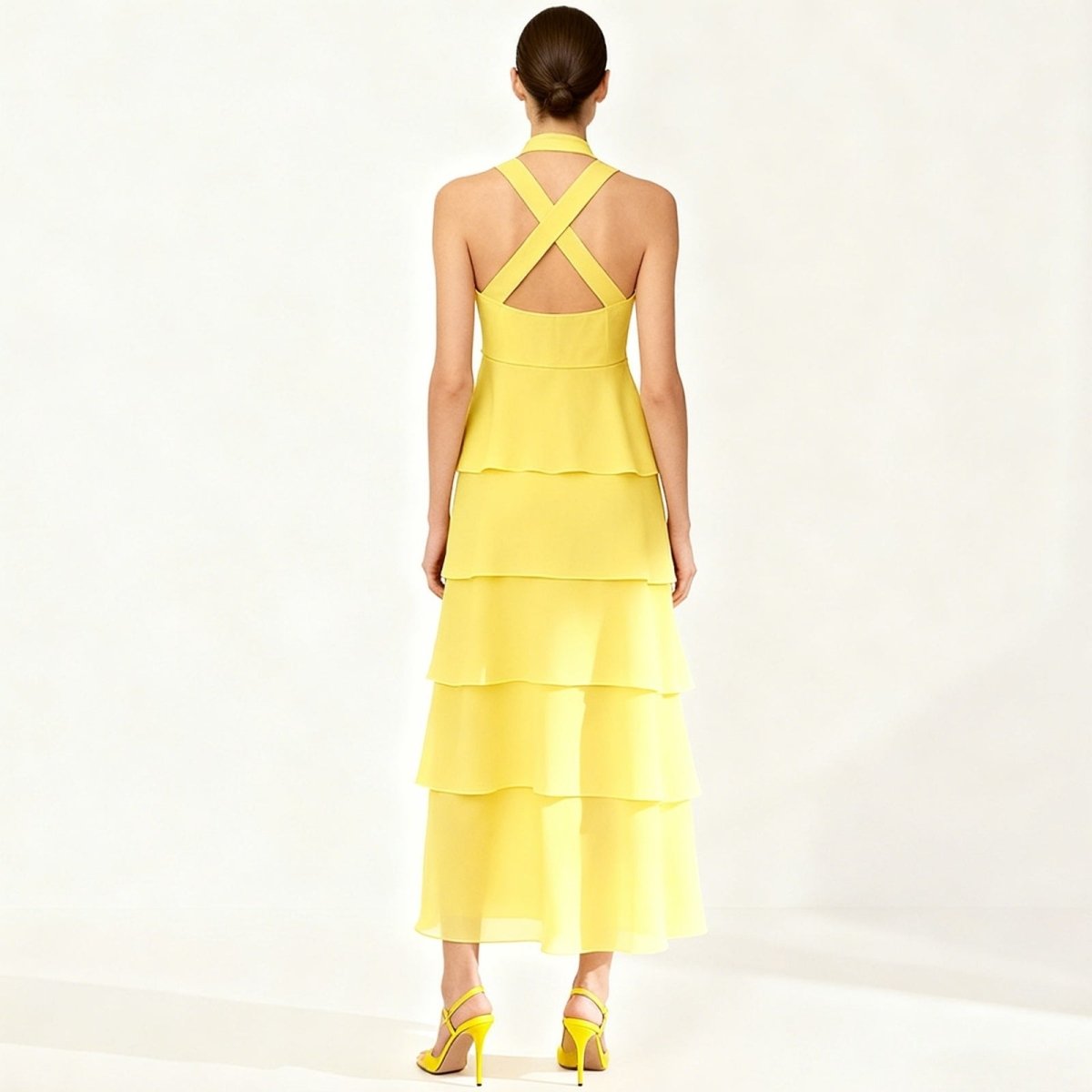 Yellow Kouvr tiered dress with criss-cross back on a white background