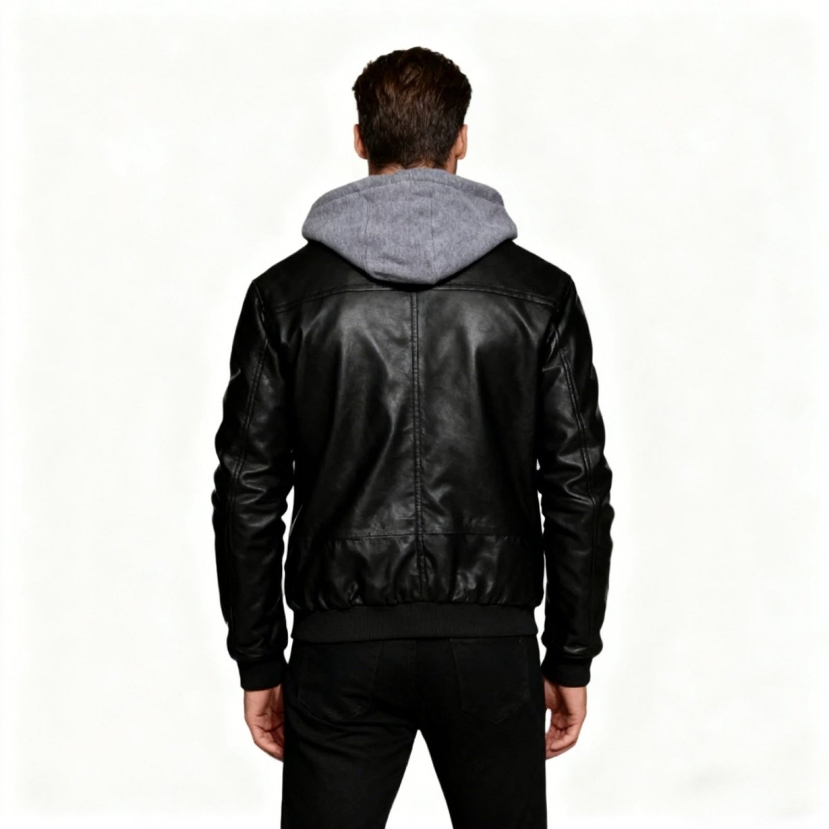 Back view of the Kouvr Ascend men's designer leather jacket, showing the seam details and the contrast of the grey fleece hood.