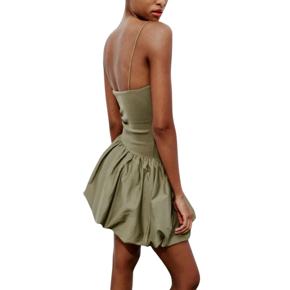 Woman wearing a green kouvr dress on a white background