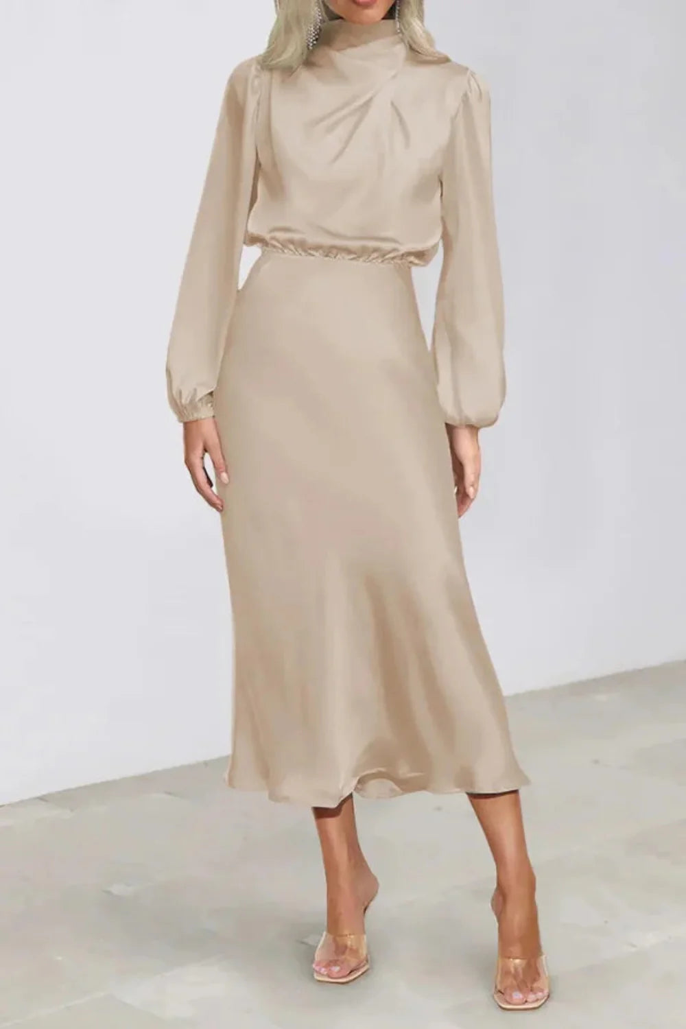 Model wearing Kouvr long sleeve beige satin midi dress with draped cowl neckline