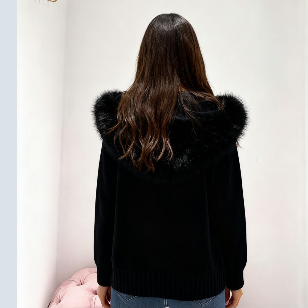 Woman wearing Kouvr black wool and cashmere blend hoodie with large fox fur trim hood