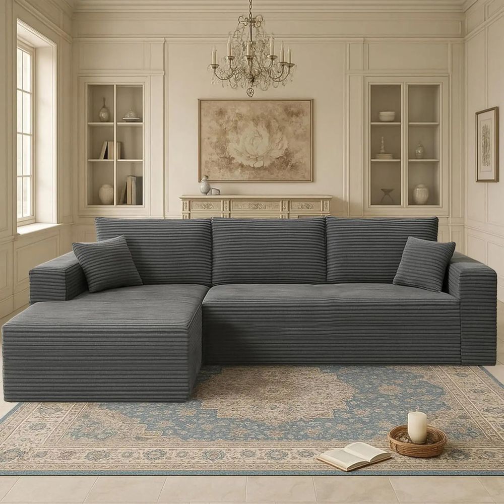 A family relaxing on the black and dark grey Kouvr deep seat corduroy sectional sofa in a brightly lit, modern living room