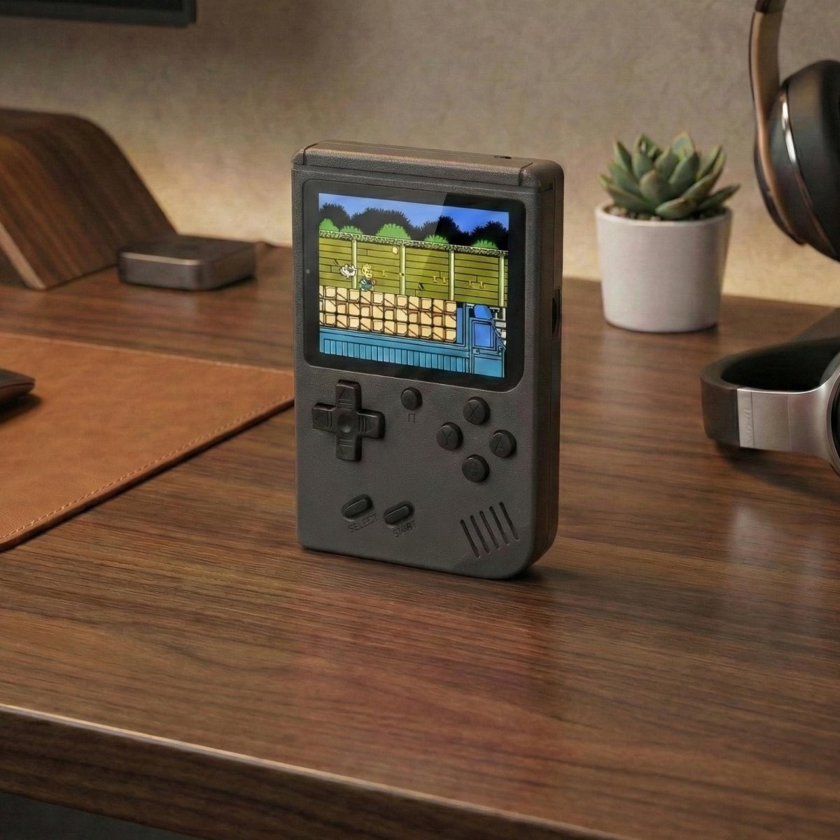 Black Kouvr retro handheld game console with a 3-inch color screen showing a classic 8-bit game.