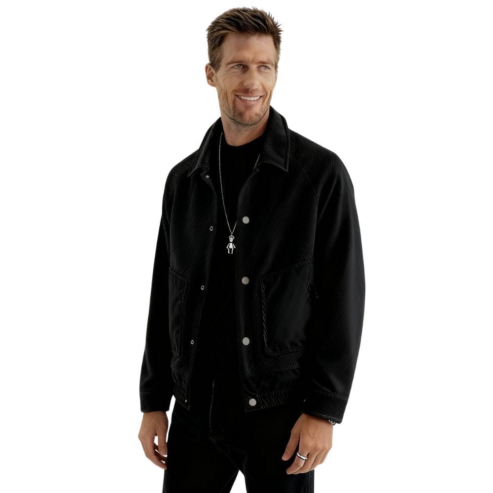Model wearing the Kouvr men's black textured corduroy and nylon trucker jacket