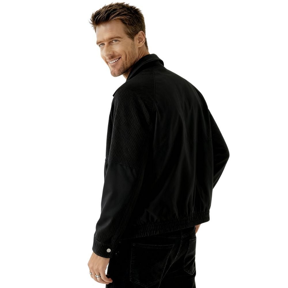 Man wearing a black kouvr jacket on a white background
