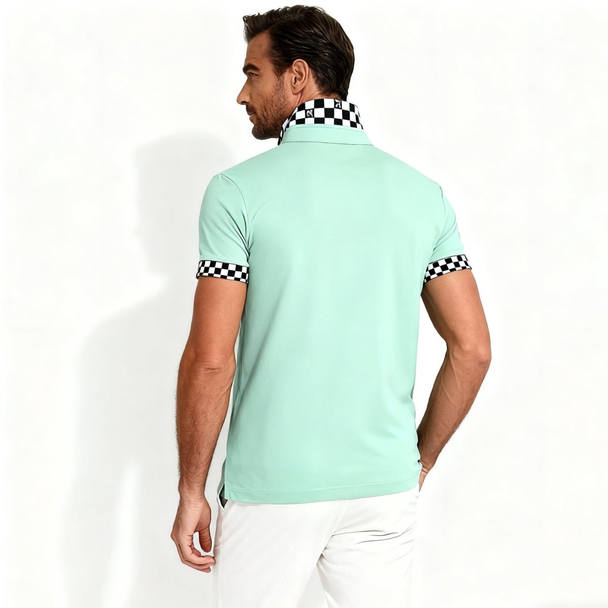 Back view of the Kouvr Fashion Brent men's polo in mint green, showcasing the unique black and white checkerboard design on the collar.