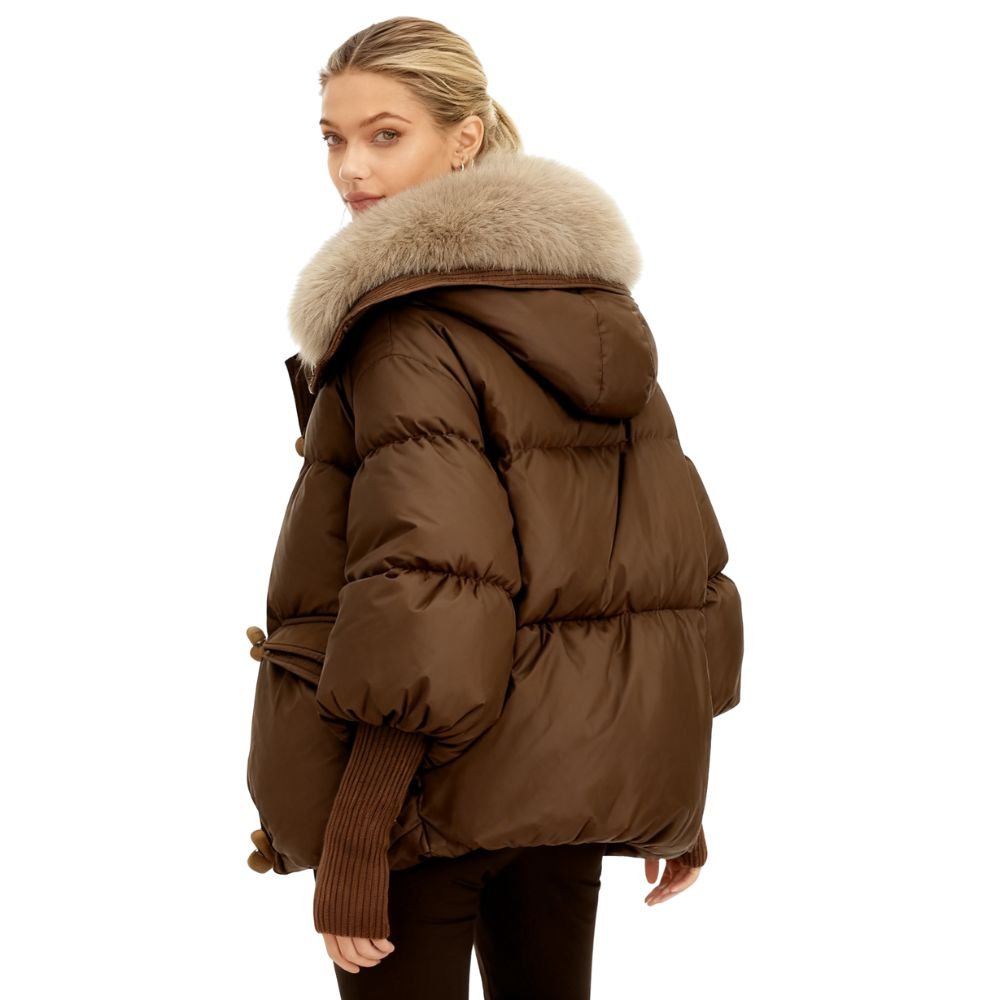 Brown kouvr puffer jacket with fur hood worn by a model on a white background