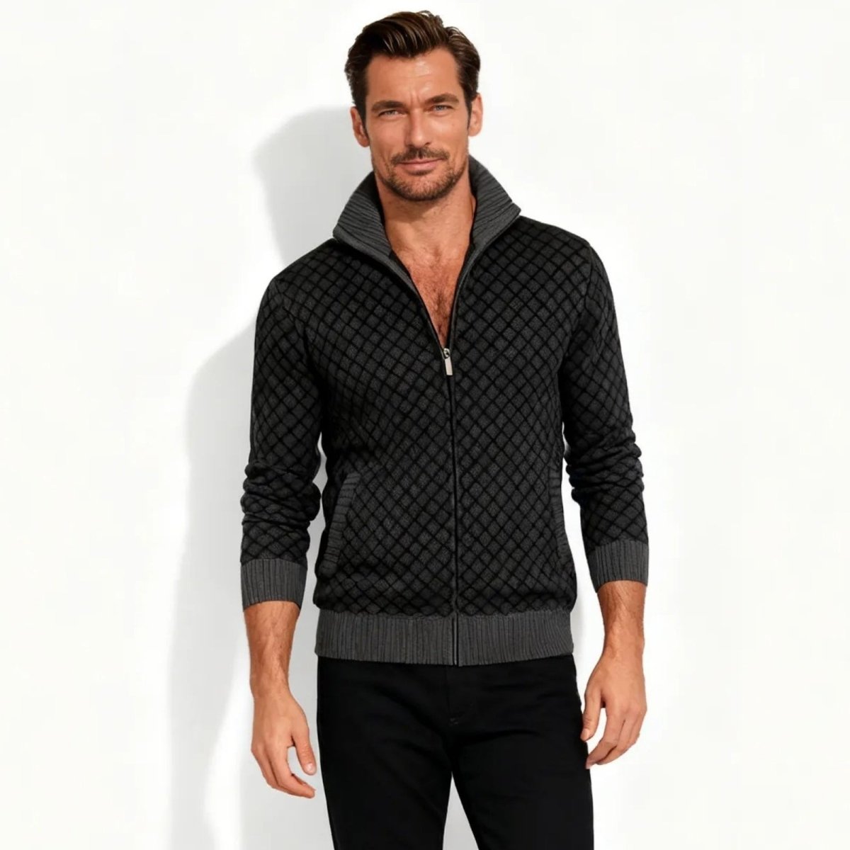man wearing the Kouvr Argento charcoal grey diamond-knit full-zip funnel neck sweater with black trousers.