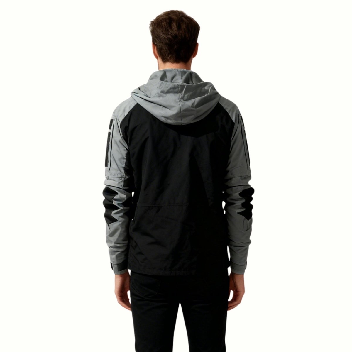 Back view of a male model wearing the Kouvr Clint Tactical Anorak, displaying the two-tone color blocking and hooded design.