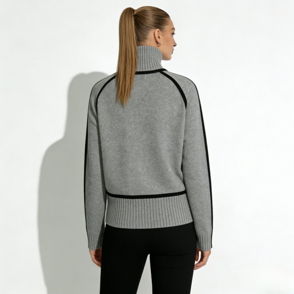 Back view of the gray raglan sleeve turtleneck with black contrast trim by Kouvr Fashion.