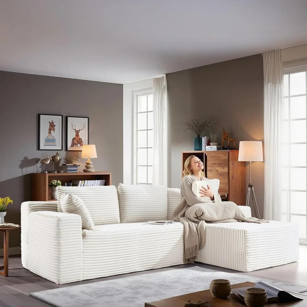 Woman relaxing on the Kouvr corduroy l-shaped cloud sofa in a modern grey living room