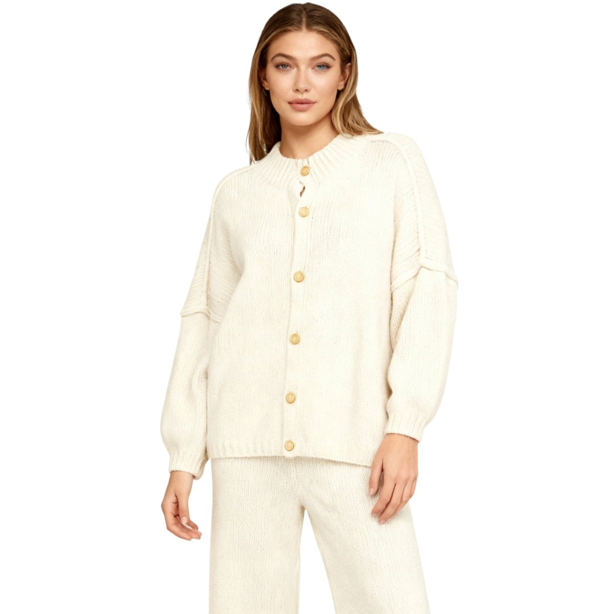 model wearing the Kouvr oversized chunky knit cardigan in cream, made from a luxurious alpaca and wool blend.