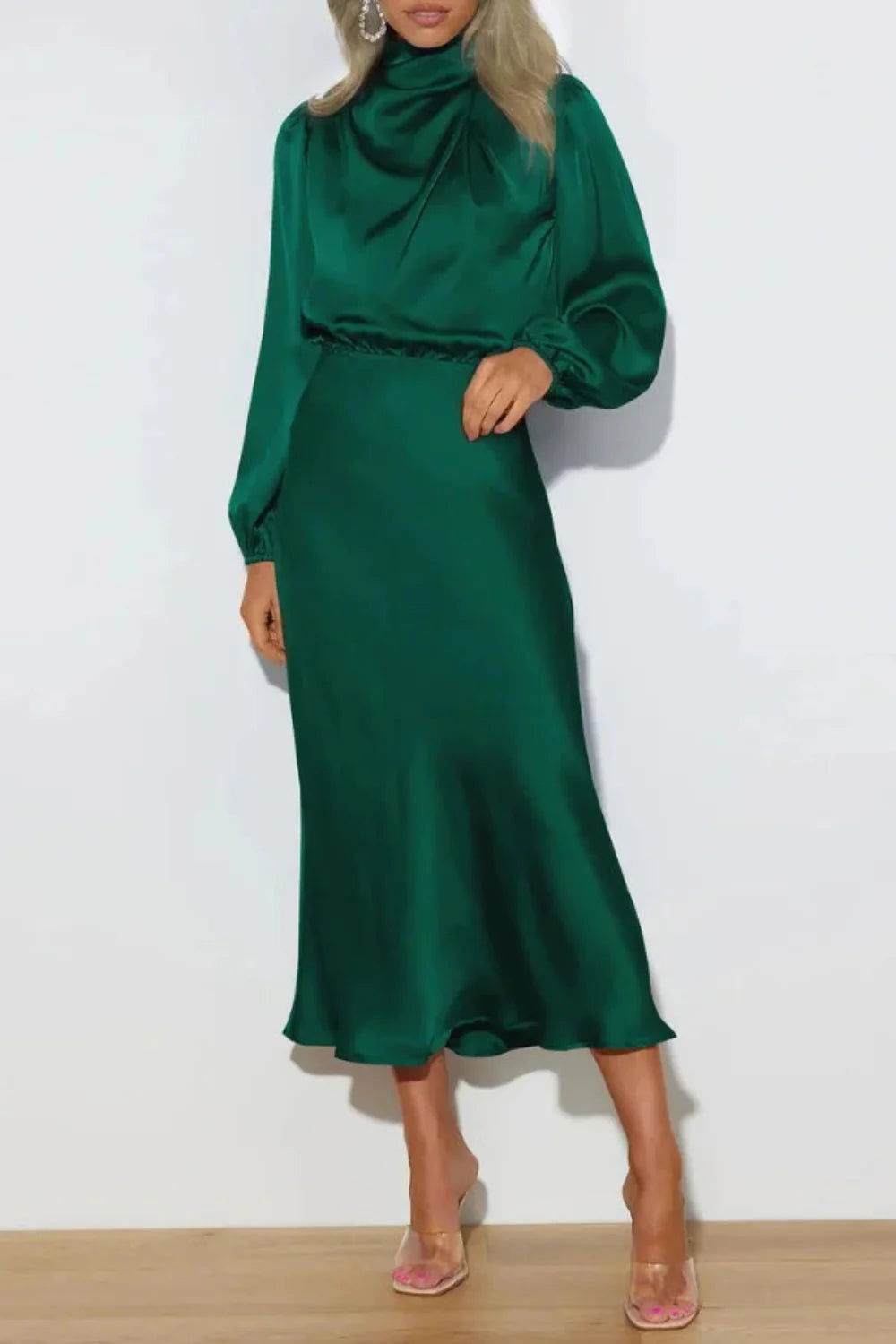 Model from the front wearing the Kouvr Ellana emerald long sleeve satin midi dress