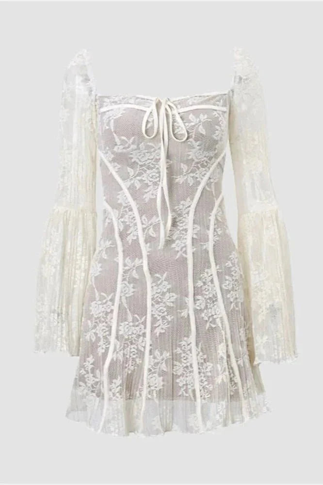 Model wearing the black Kouvr Elysia lace corset mini dress with long bell sleeves against a white background