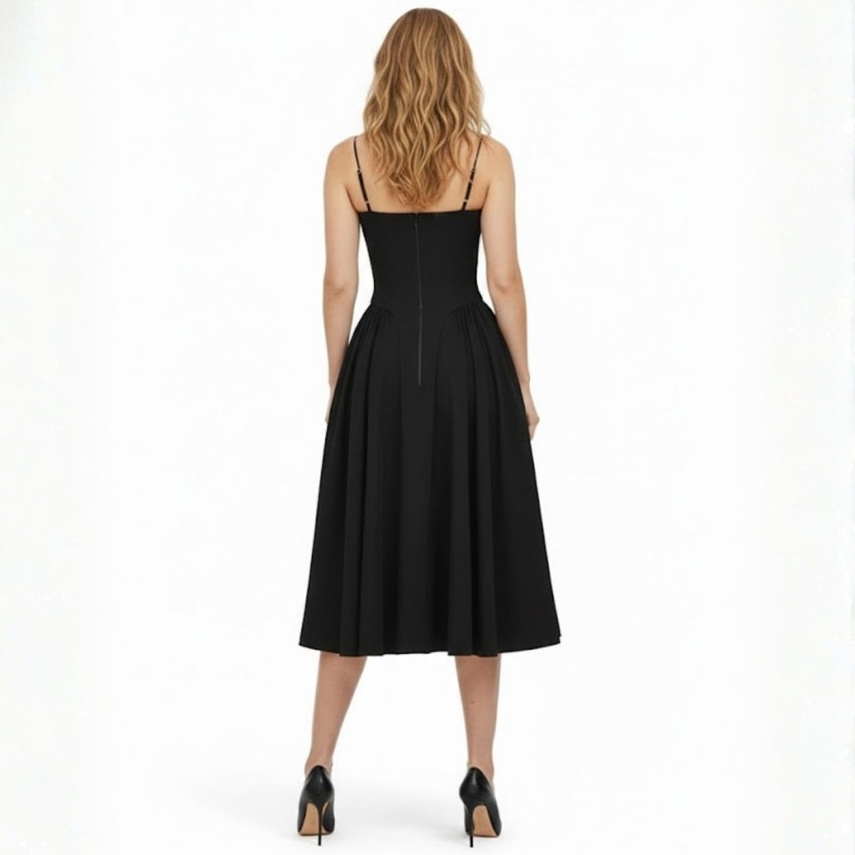 Back view of the Kouvr Evdokia black cocktail dress, displaying the spaghetti straps and concealed zipper closure on the fitted bodice.
