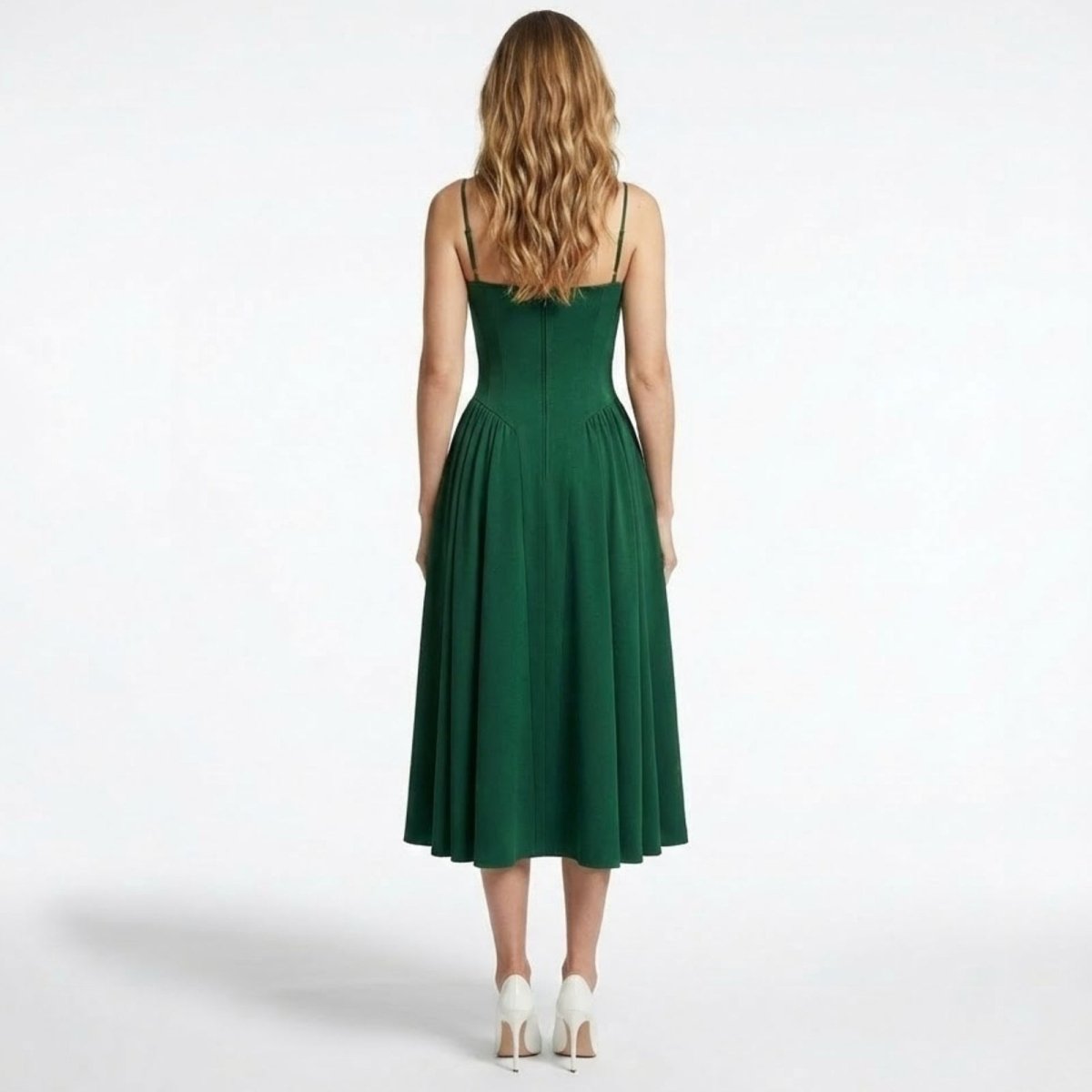 Back view of the Kouvr Evdokia emerald green dress, detailing the spaghetti straps and seam work on the structured bodice.