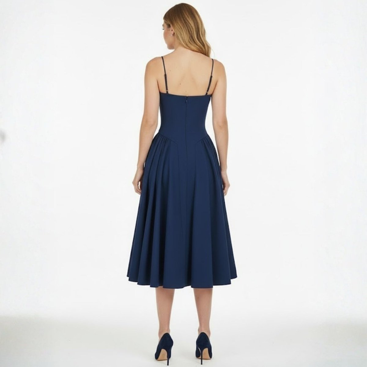 Back view of the Kouvr Evdokia dress in navy, displaying the thin spaghetti straps and concealed zipper closure on the model.