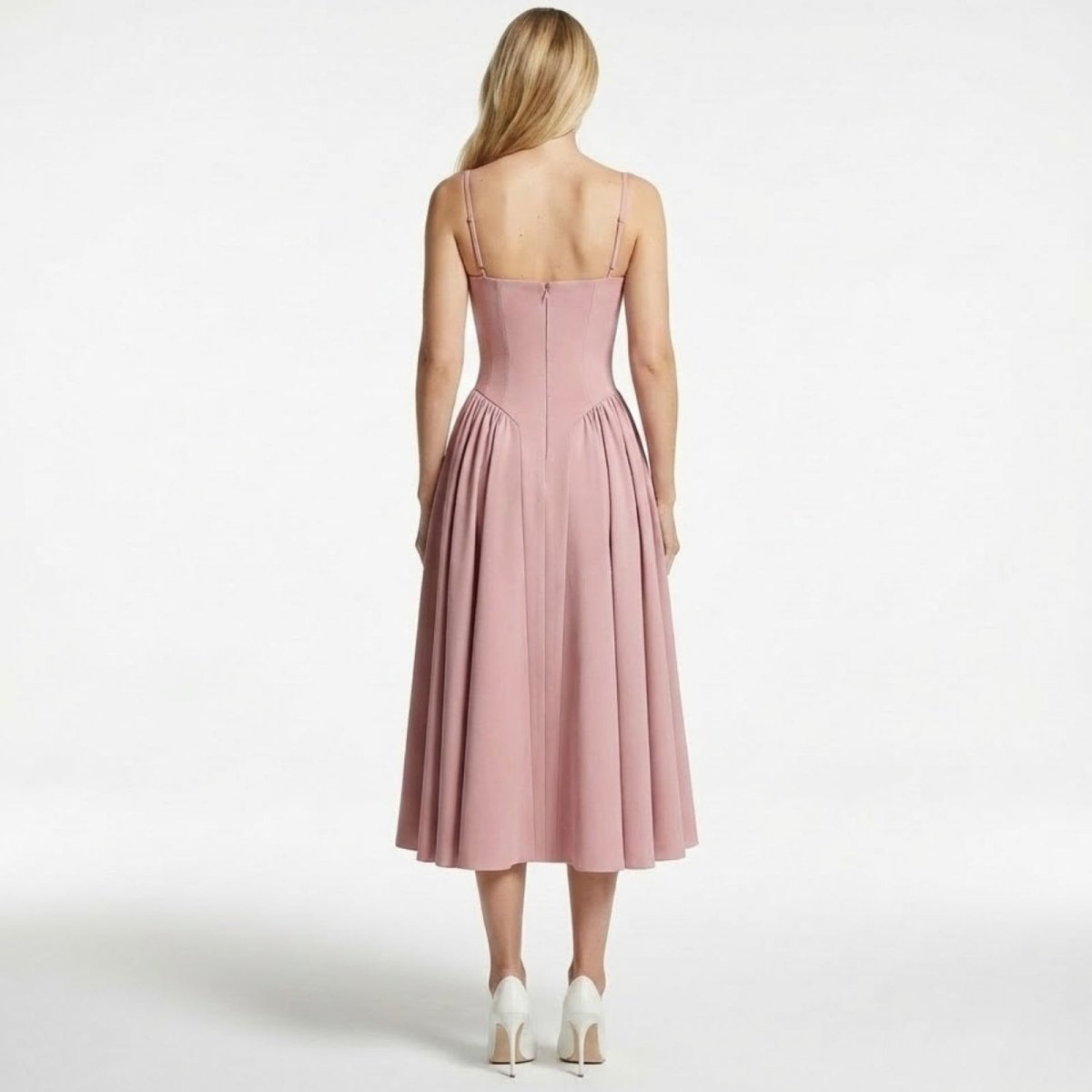 Back view of a model in the Kouvr Evdokia dress in pink, detailing the spaghetti straps and hidden zipper closure.