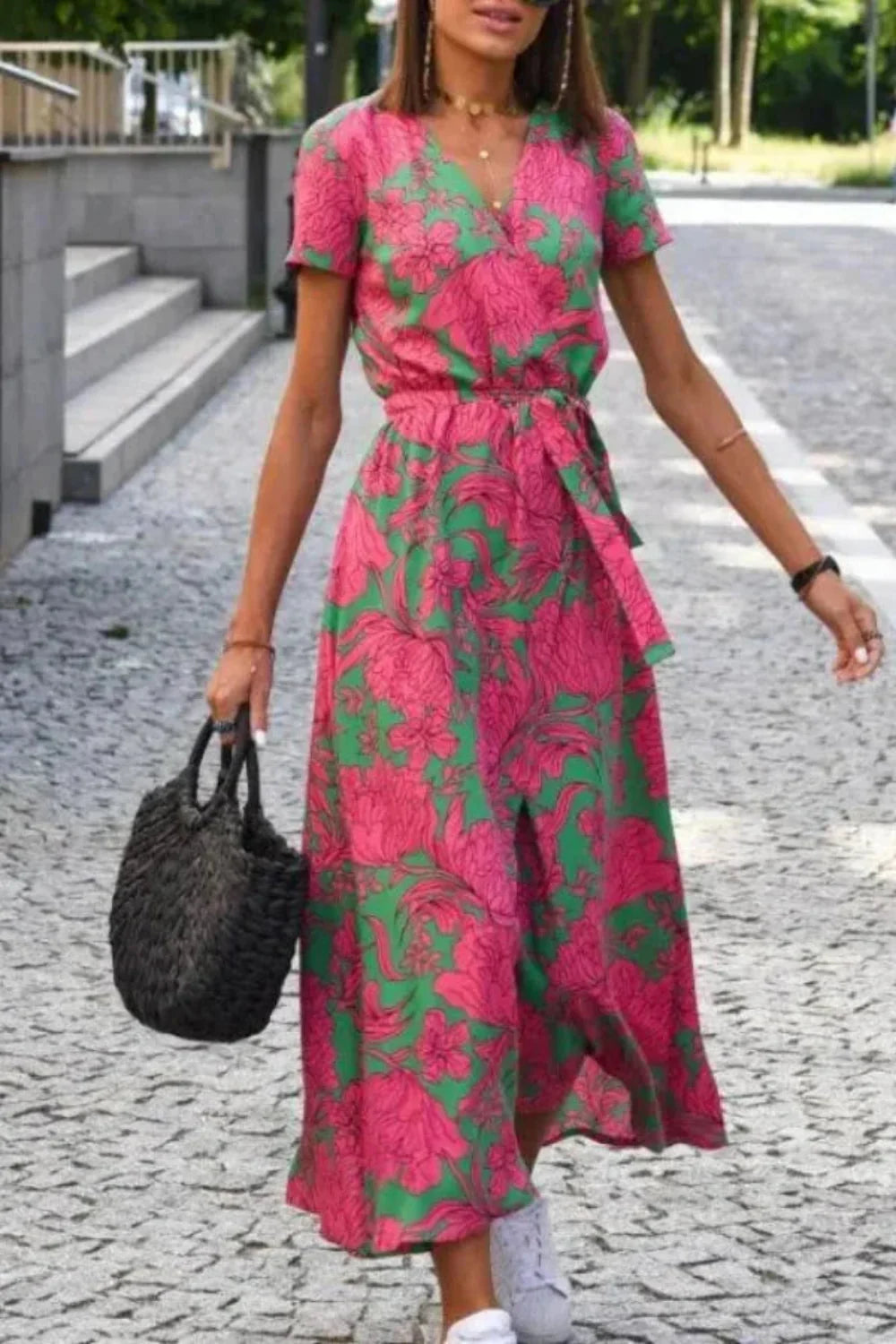 Front view of the Aleia pink floral wedding guest dress with V-neck and tie-waist.
