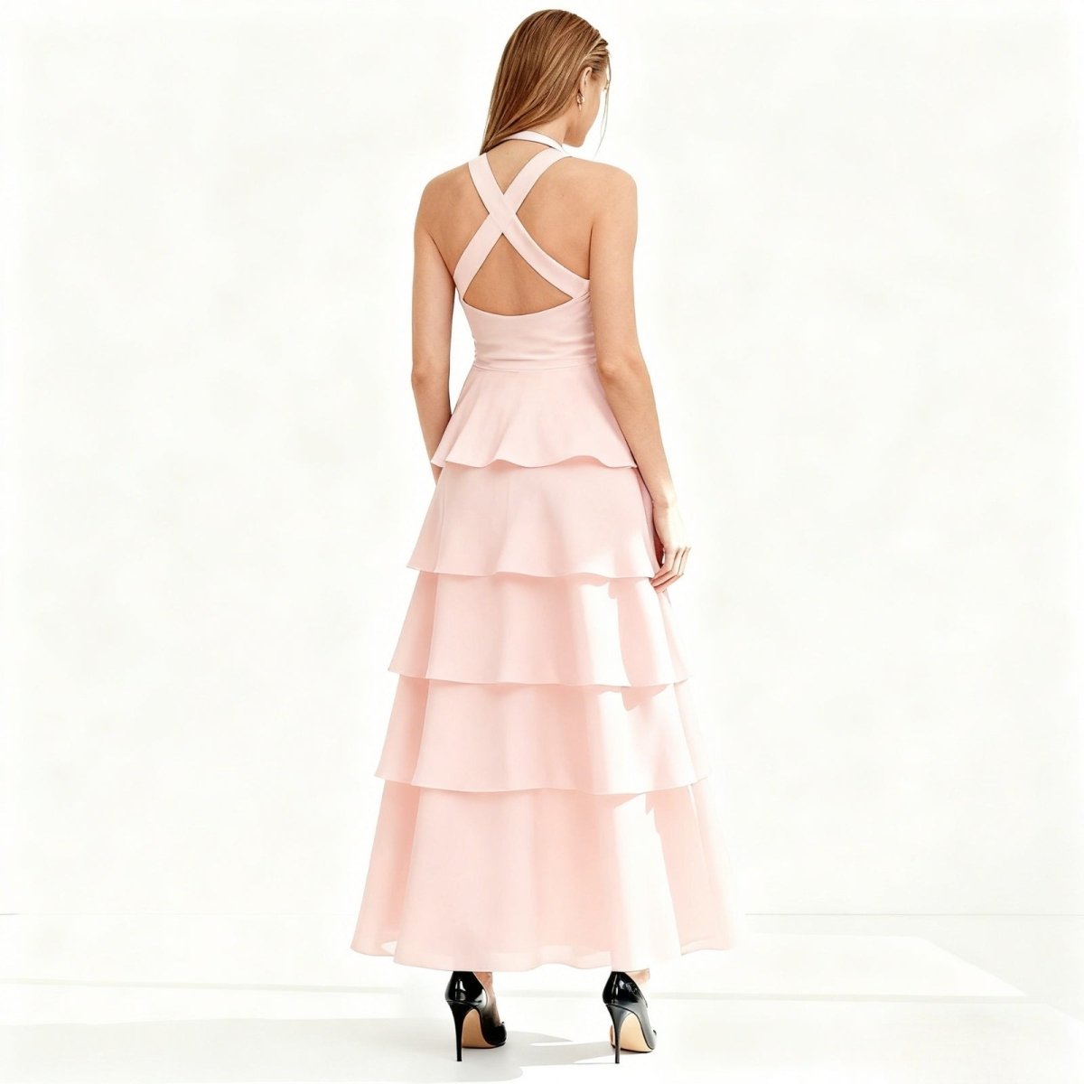 Pink Kouvr tiered dress with criss-cross back on a white background