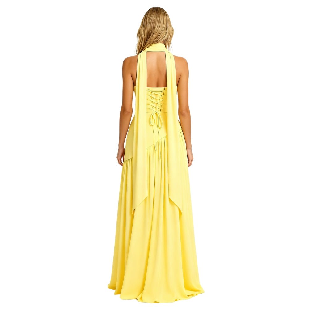 Woman Kouvr wearing a yellow halter neck dress on a white background