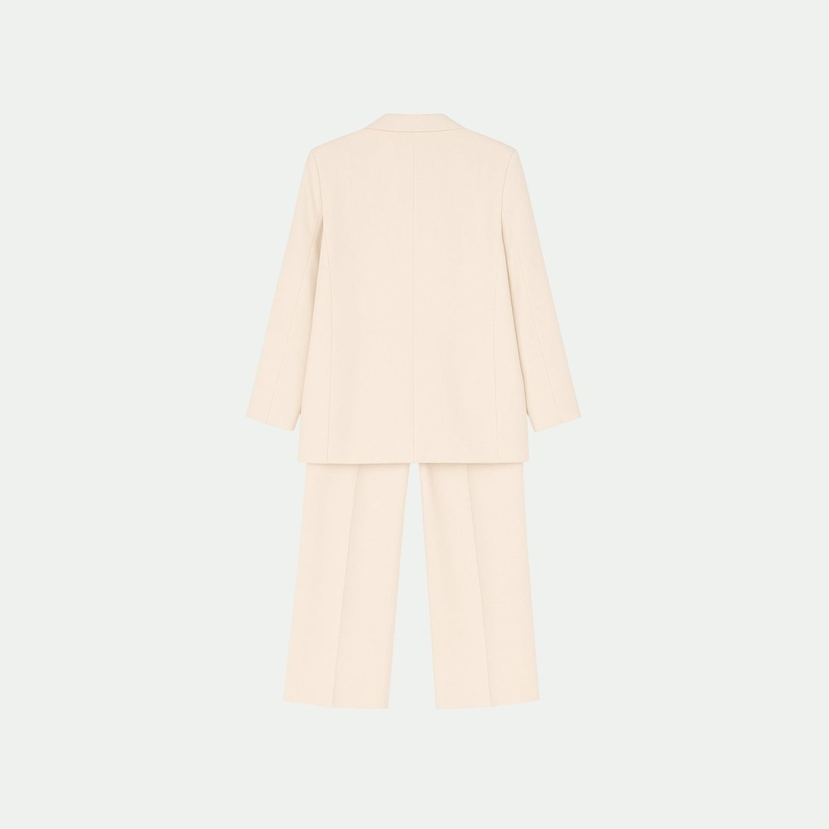 Back view flat lay of the Kouvr Fashion apricot blazer and trouser set, displaying the clean construction and minimalist design of the luxury suiting.