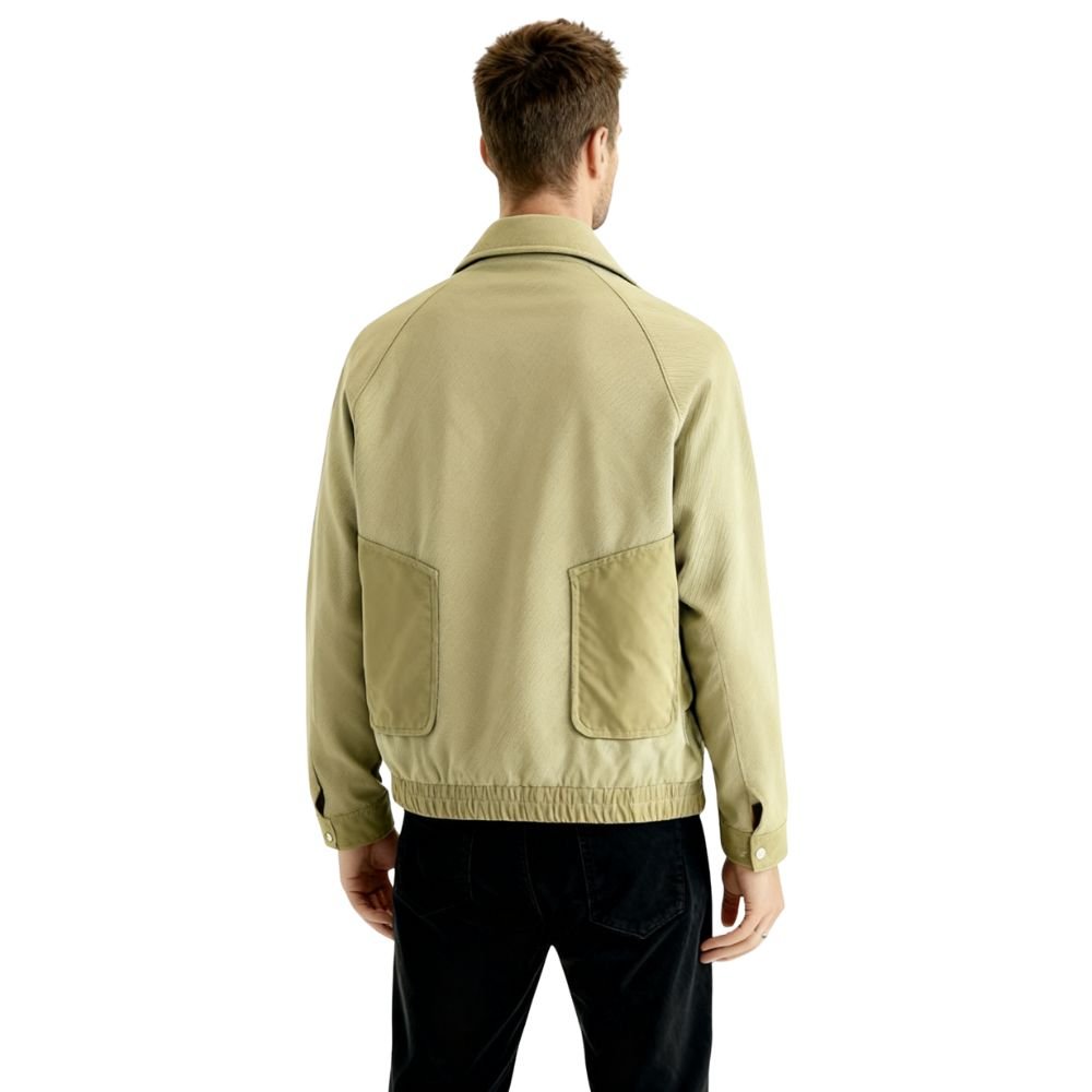 Man wearing a khaki kouvr jacket on a white background