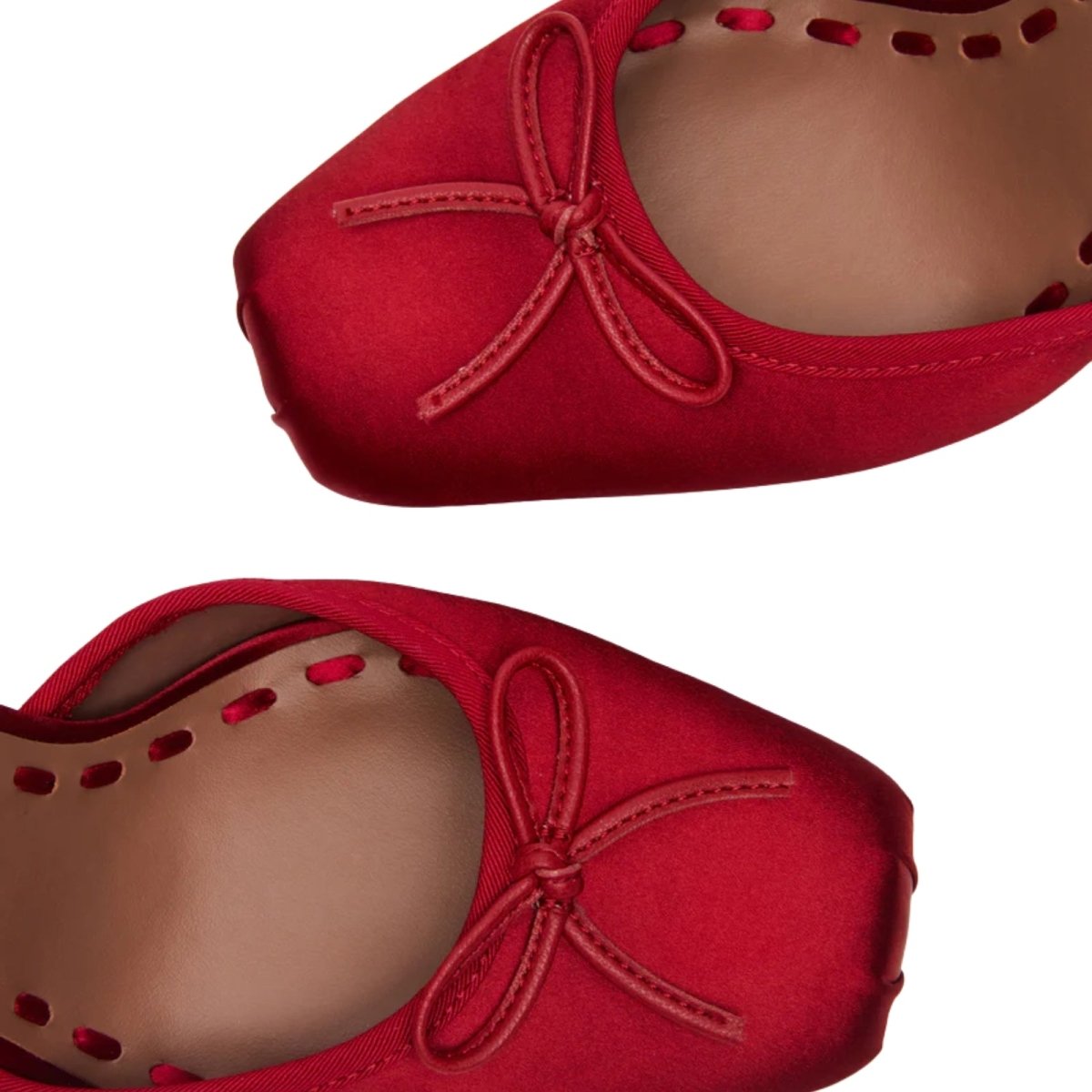 Red kouvr ballet flats with a bow detail on a white background
