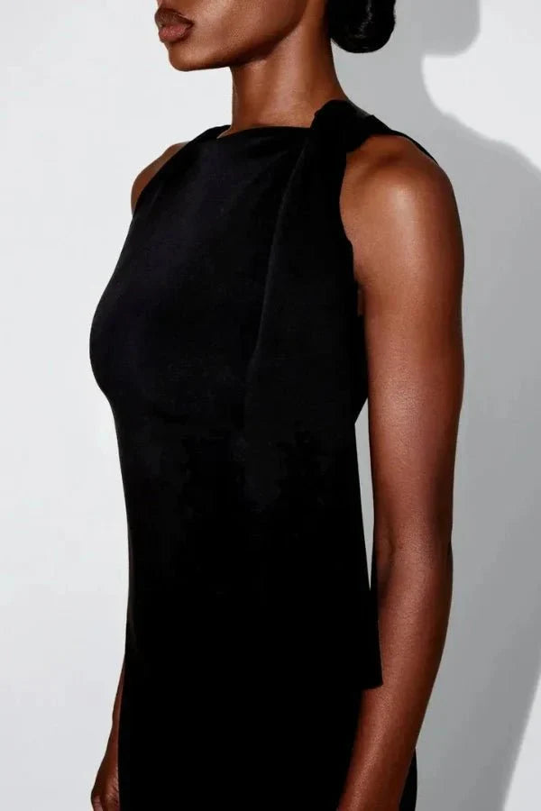 column silhouette," "draped shoulder," "floor-skimming hem," "minimalist aesthetic," "understated elegance