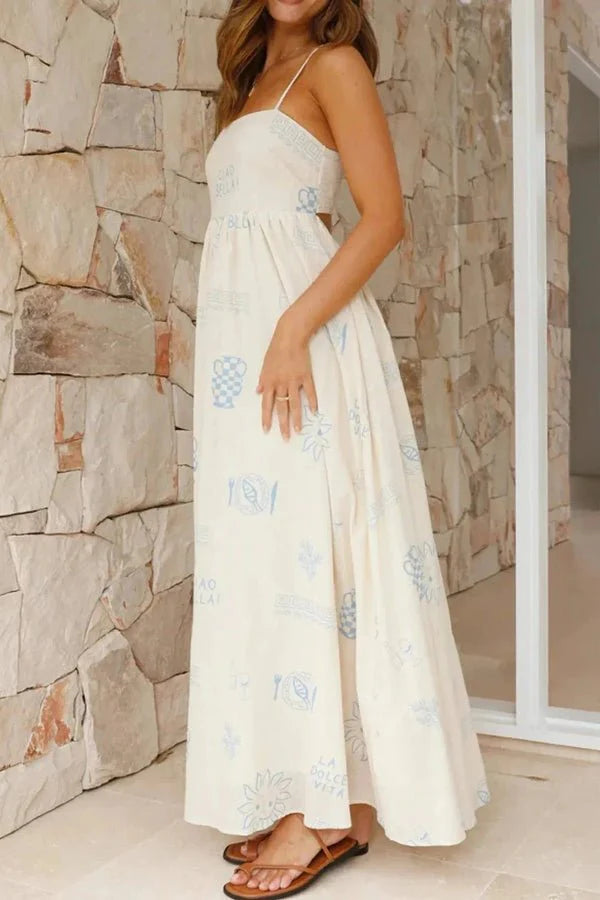 Model wearing the Kouvr Fashion Carra linen maxi dress with blue Italian print against a stone wall