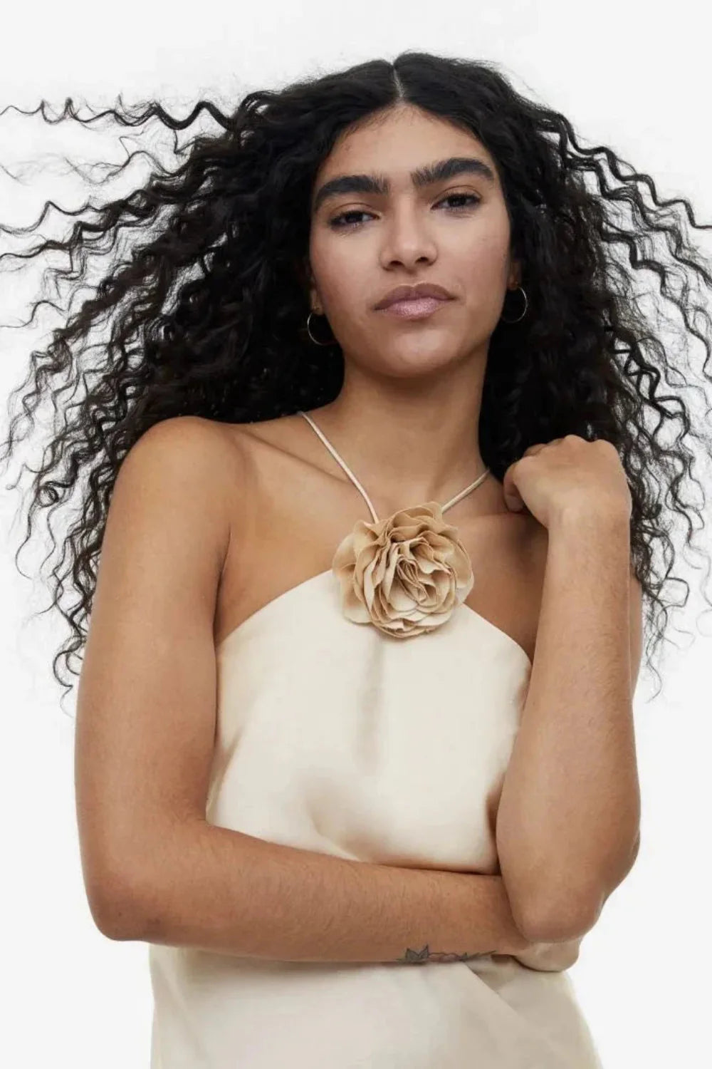 Model from behind wearing the Kouvr Fashion Cathalina beige satin halter dress showing the open back and criss-cross straps