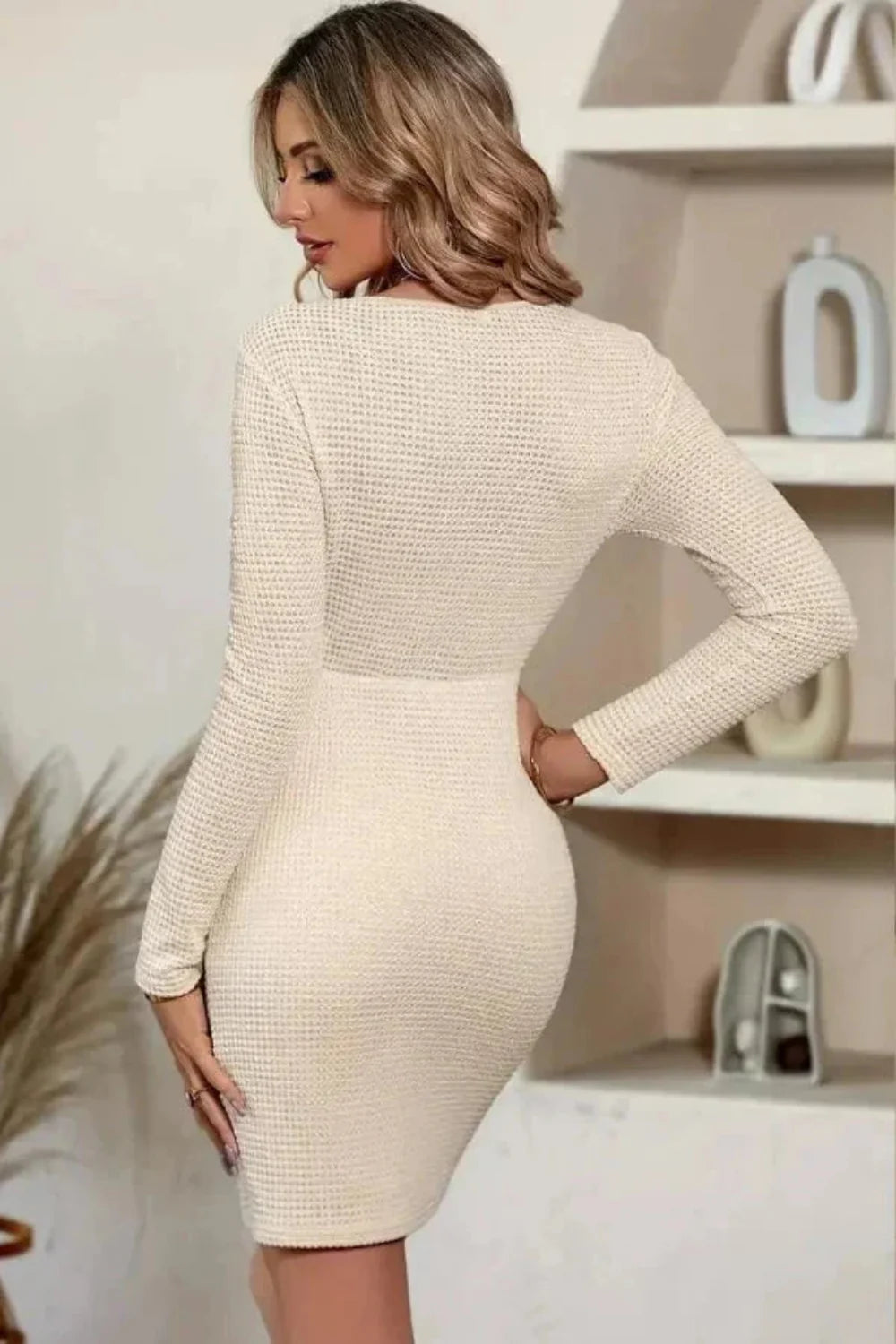 Model wearing The Claudia ruched waffle knit bodycon dress in apricot by Kouvr Fashion