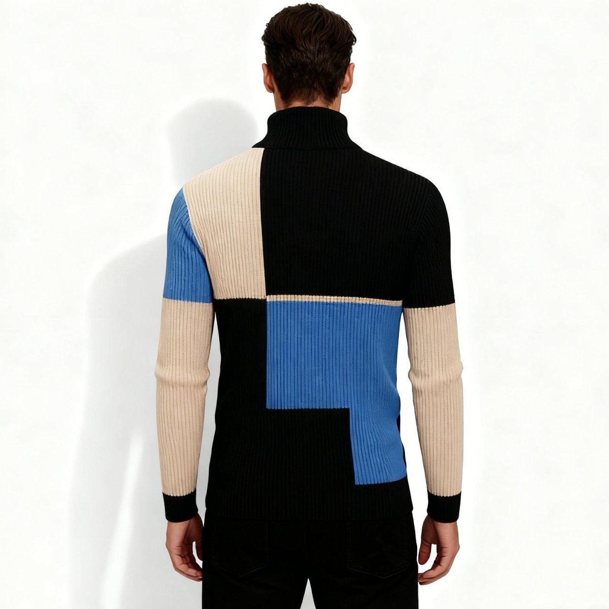 Back view of the Kouvr Fashion color block turtleneck sweater on a male model, showing the full geometric pattern.