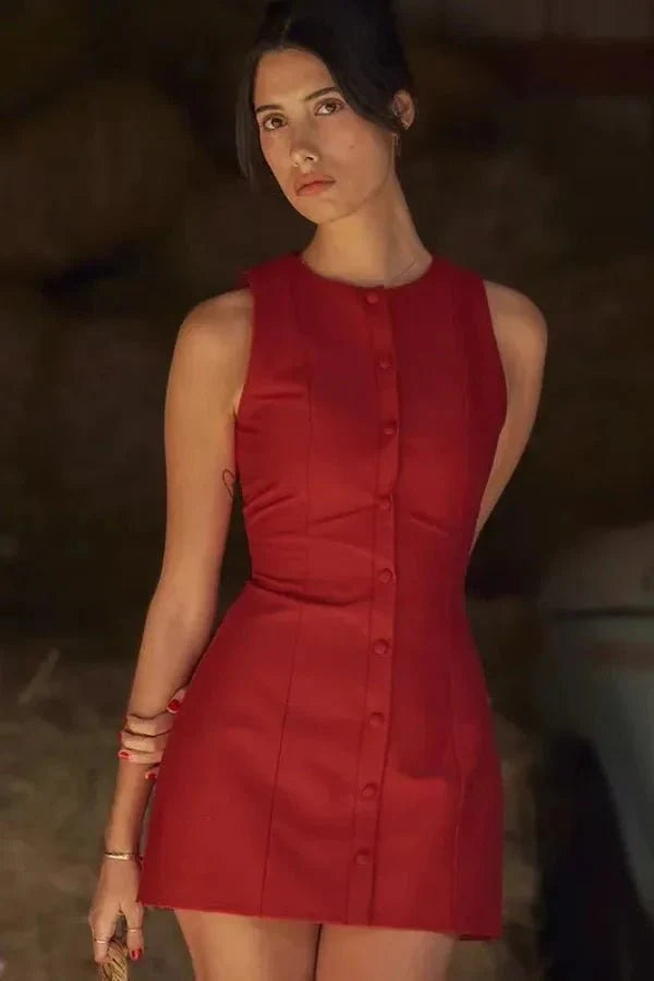 Model wearing the Kouvr Cosette sleeveless red mini dress in a rustic setting