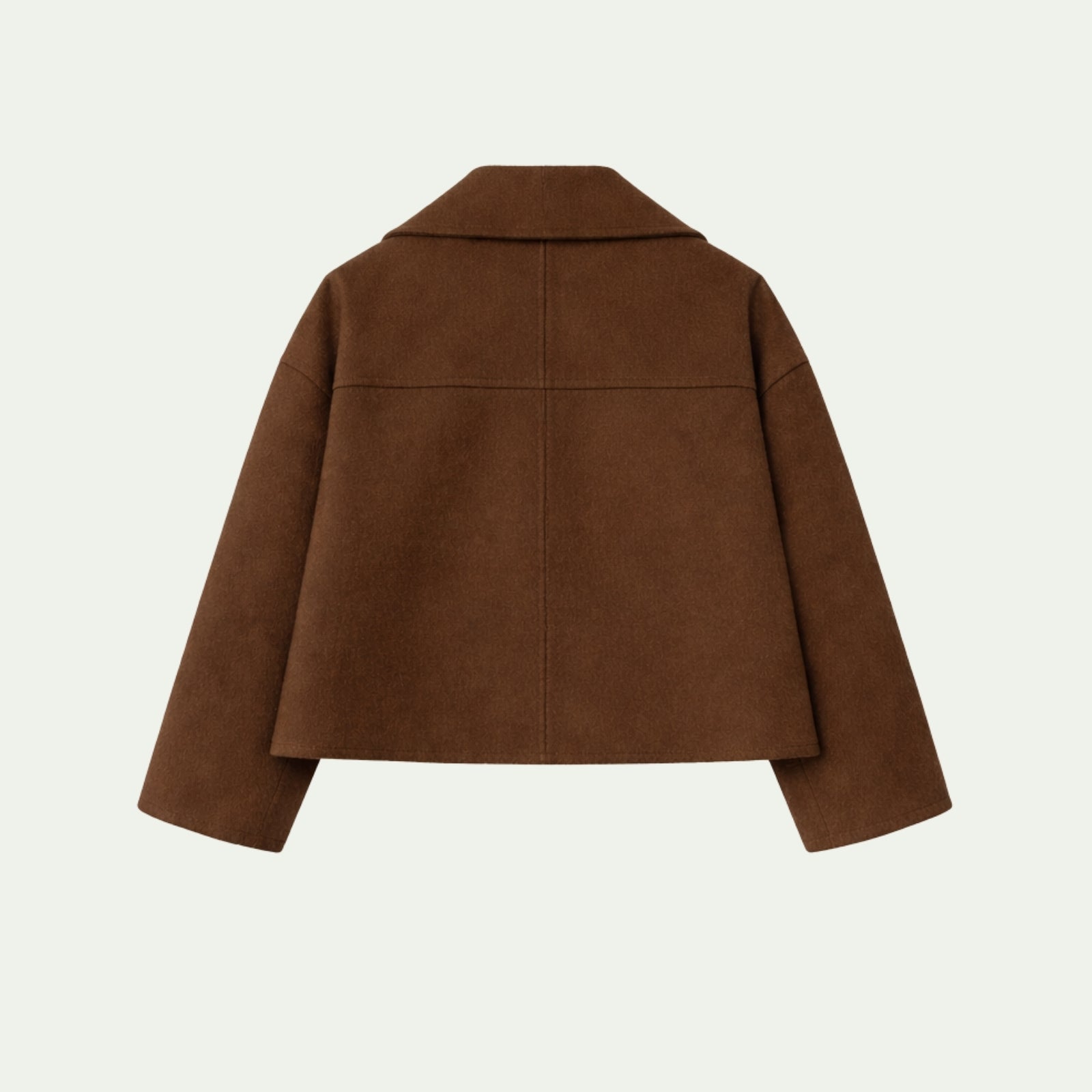 Back detail flat lay of the Kouvr Fashion cropped wool jacket showing the yoke seam construction and fabric texture.