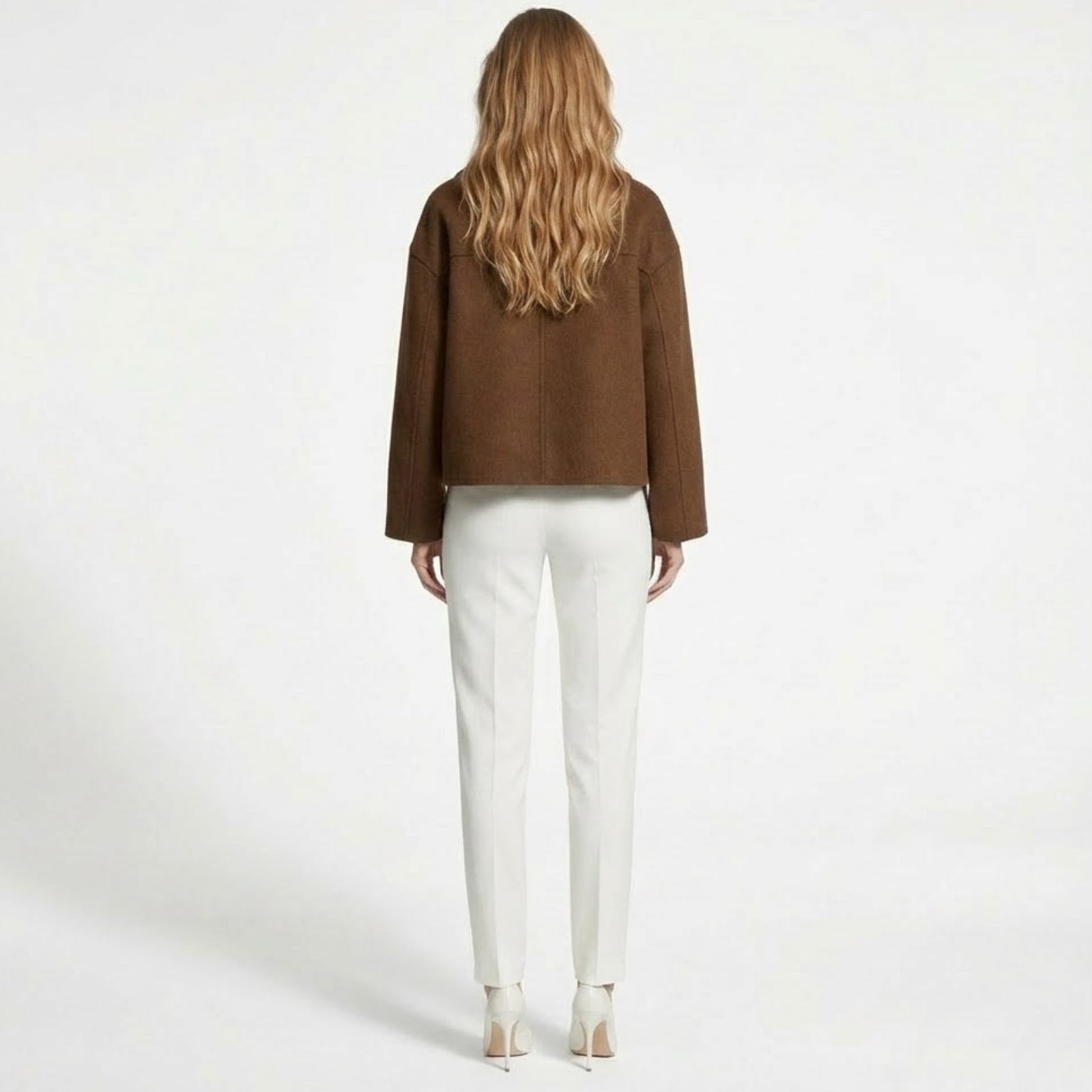 Back view of the Kouvr Fashion cropped wool jacket in cognac brown, highlighting the central seam and structured fit.