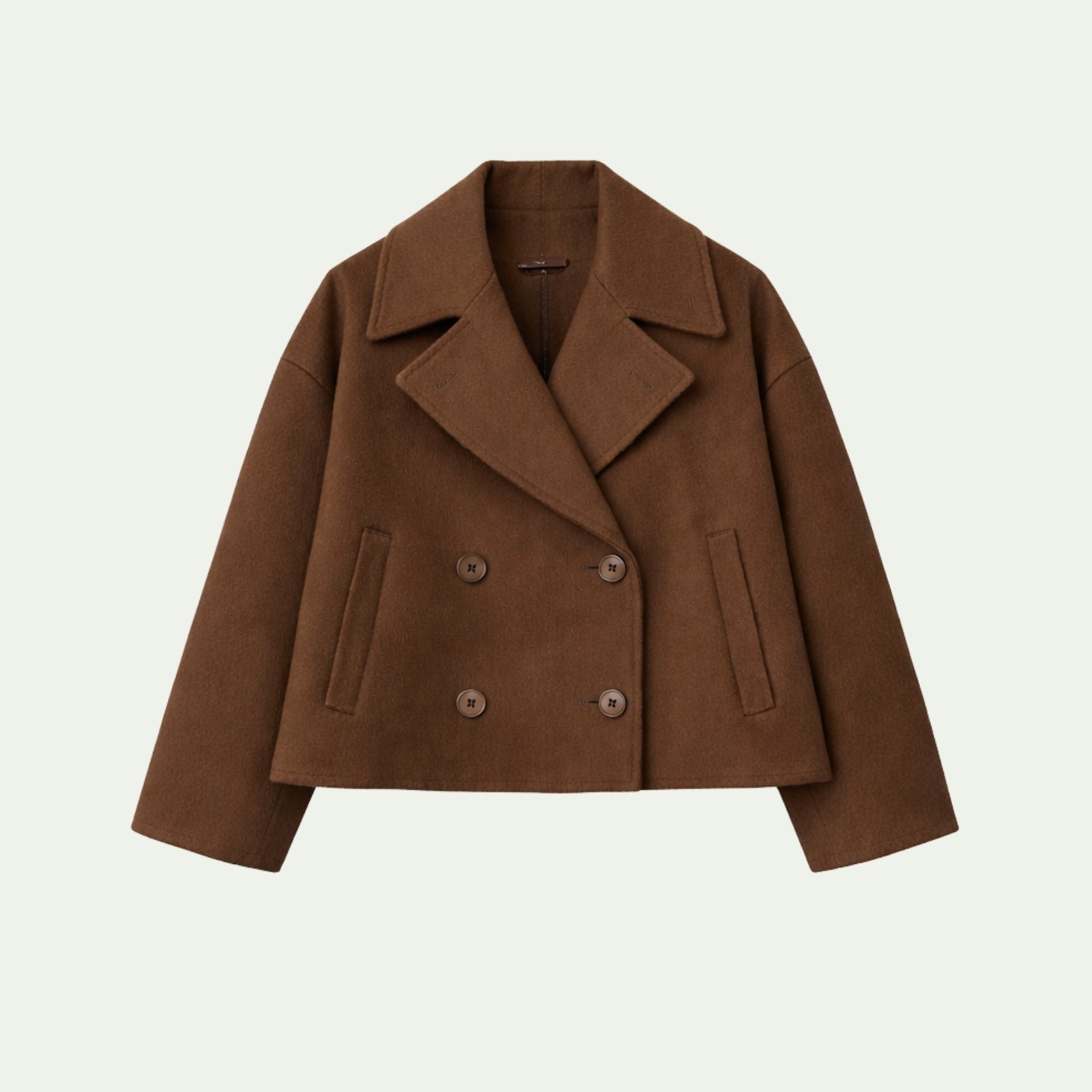 Flat lay of the Kouvr Fashion double-breasted cropped wool jacket in cognac brown showcasing its buttons and wide lapels.